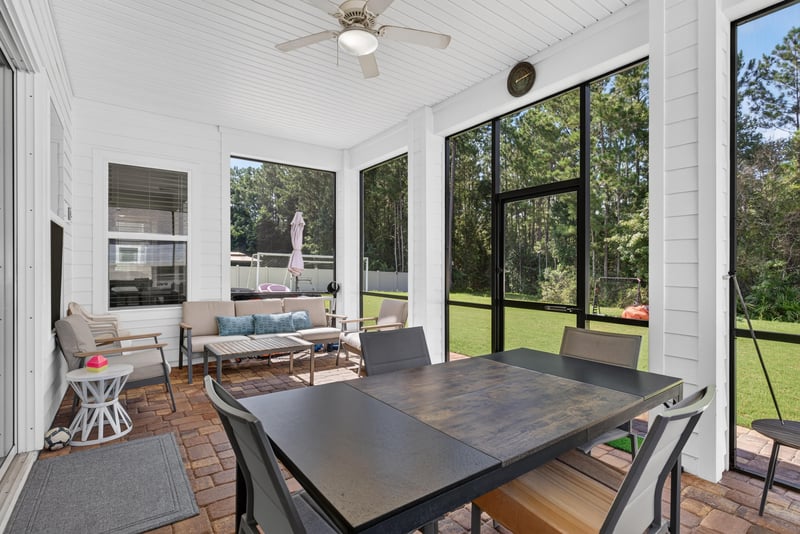 Screened porch with dining table at 22 Azura Point