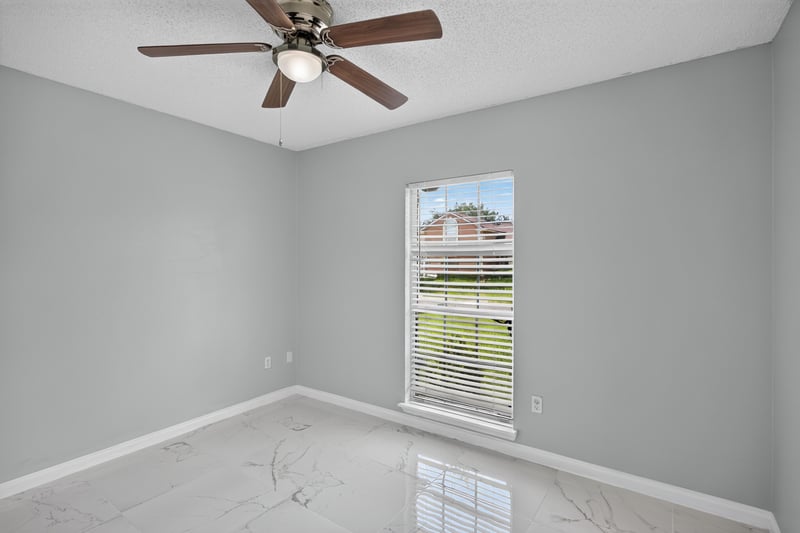 Bedroom with ceiling fan and window at 490 Hillside Dr, Orange Park, FL 32073