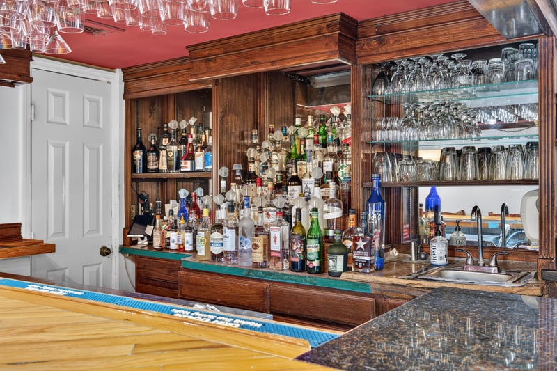 Bar with mirrored shelving and glassware at 115 Cordova St, St. Augustine, FL