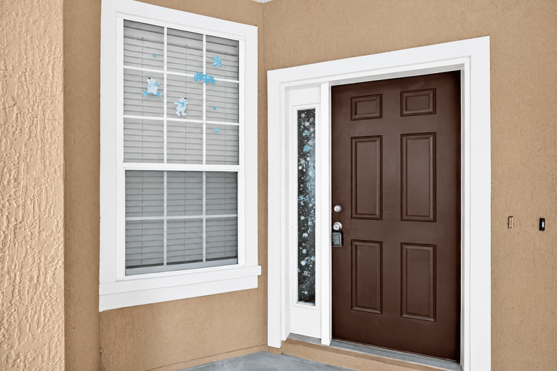 Front entry door with sidelight window at 3762 Hartsfield Forest Cir, Jacksonville, FL 32277