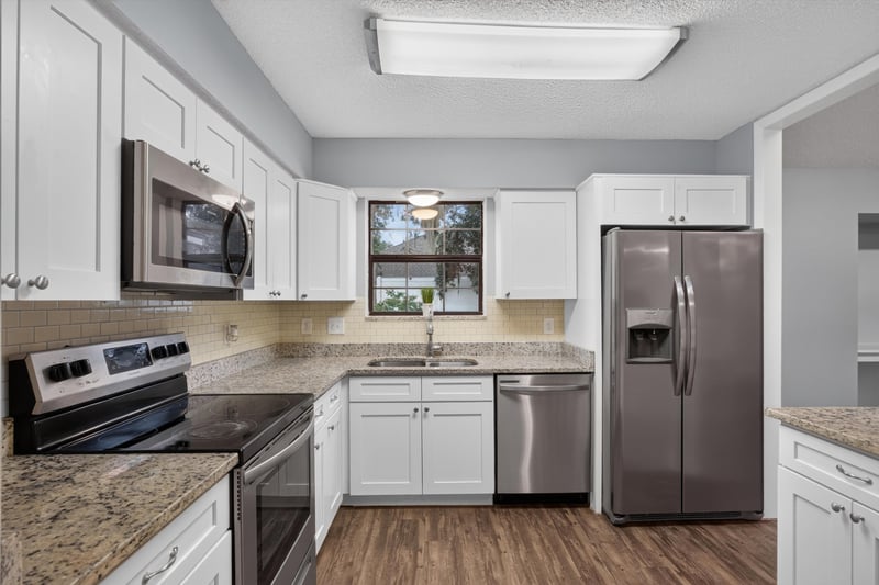 Kitchen with stainless appliances and tile backsplash at 12344 Cormorant Ct, Jacksonville, FL