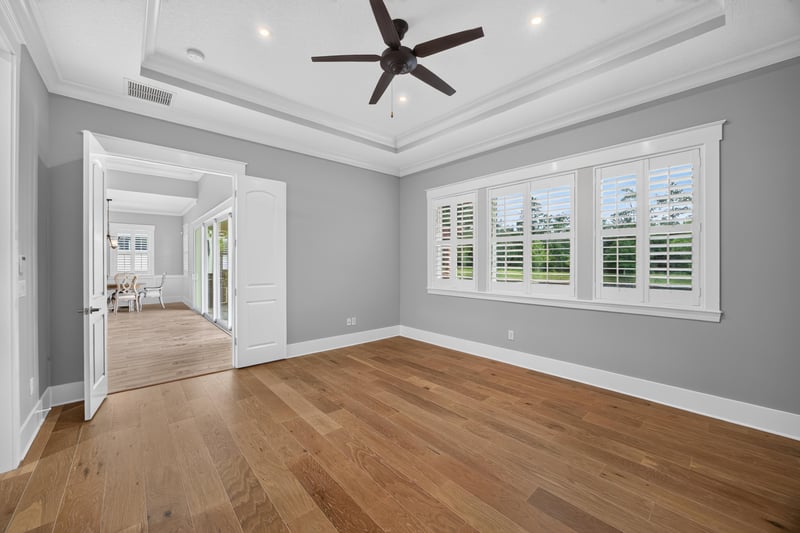 Primary bedroom with tray ceiling and ceiling fan at 186 Freshwater Dr