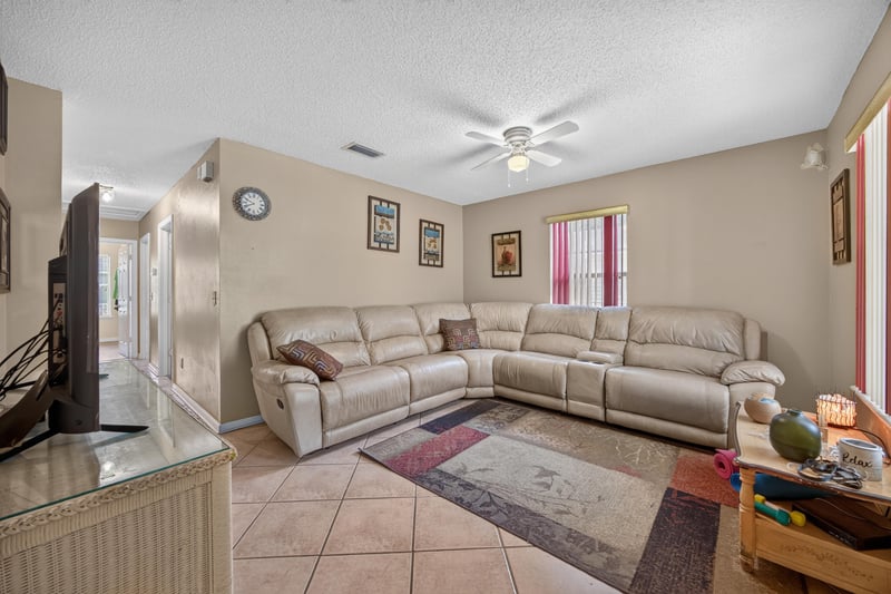 Living room with tile floor and sectional sofa at 5375 Dodge Rd, Jacksonville, FL 32209