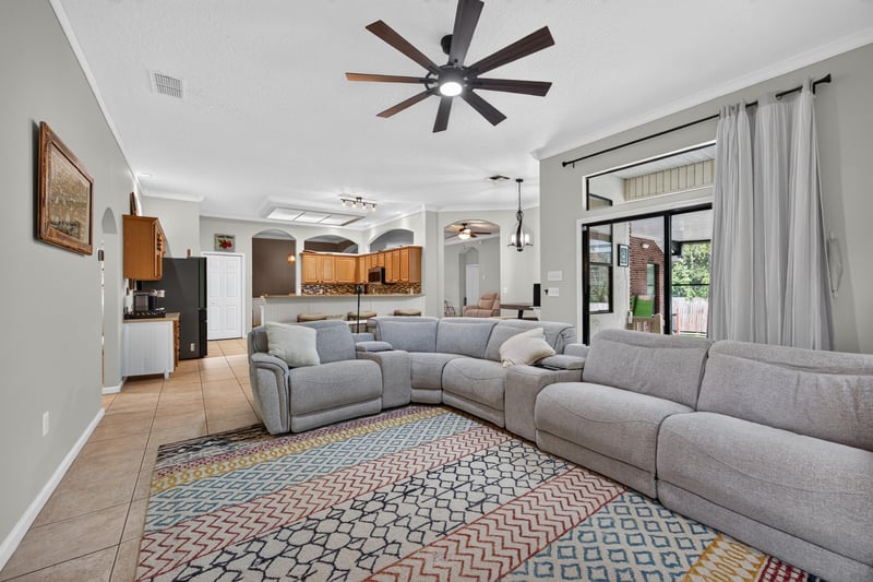 Living room open to kitchen with sectional sofa at 2125 Blue Heron Cove Dr, Orange Park, FL 32003