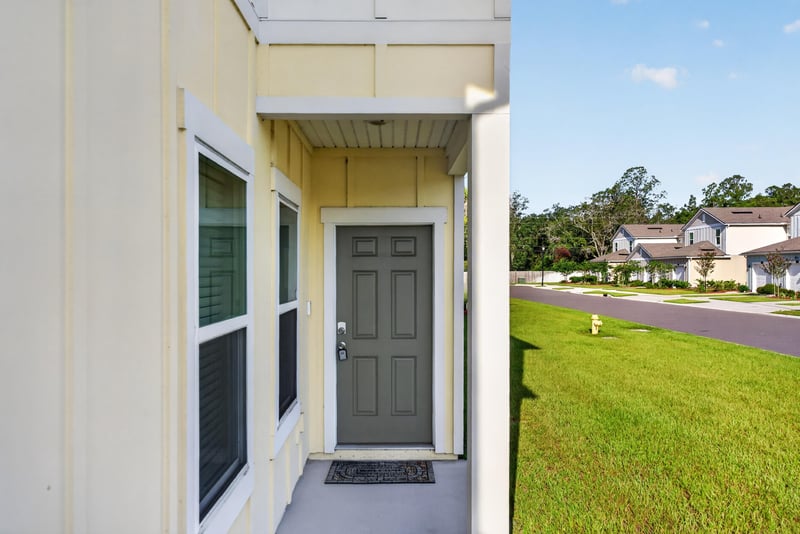 Front entry door framed by sidelight window at 4024 Bay Hawk Ct, Jacksonville, FL