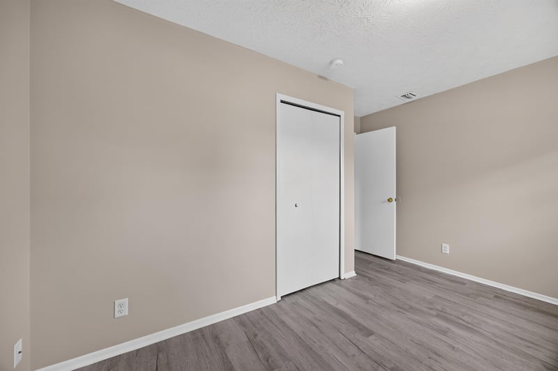 Empty room with door and wood-look flooring at 1083 Stokes St, Jacksonville, FL