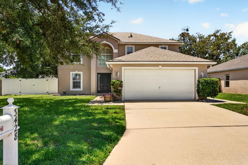 Front exterior with two-car garage and lawn at 3428 Glenn Hollow Ct, Jacksonville, FL 32226