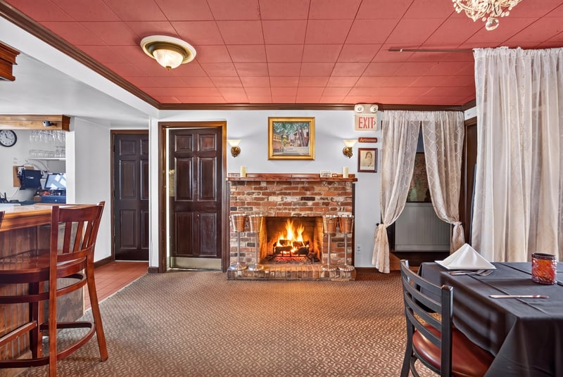 Dining room with brick fireplace and table settings at 115 Cordova St, St. Augustine, FL