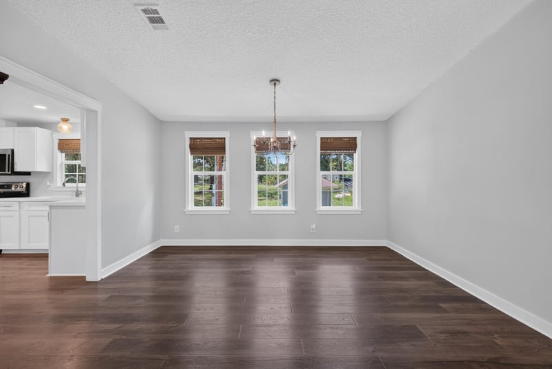 Dining area with chandelier and large windows at 4890 McAllister Rd, Middleburg, FL 32068
