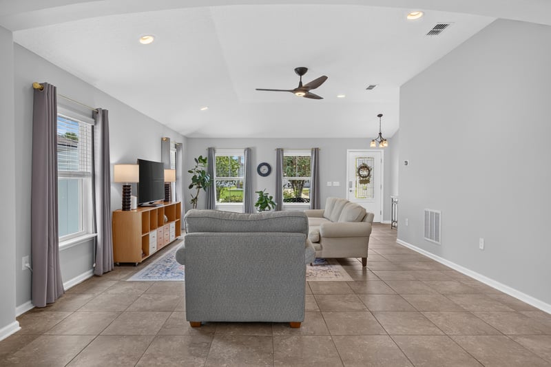 Living room seating area with TV console at 85 Amia Dr, St. Augustine, FL 32086