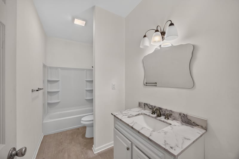 Bathroom vanity with mirror and tub-shower at 1012 Fruit Cove Rd, Jacksonville, FL 32259