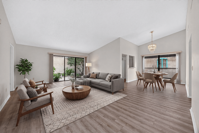 Staged living and dining area with vaulted ceiling at 3407 Fairbanks Grant Rd N, Jacksonville, FL 32223