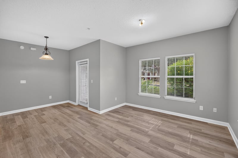 Empty living room with wood-look flooring at 575 Oakleaf Plantation Pkwy, Orange Park, FL 32065