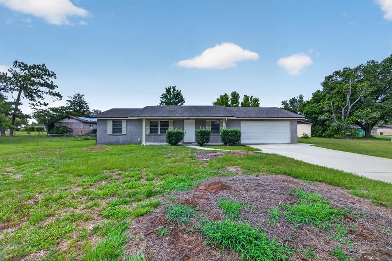 Front exterior angle showing lawn and driveway at 1143 Tumbleweed Dr, Orange Park, FL 32065