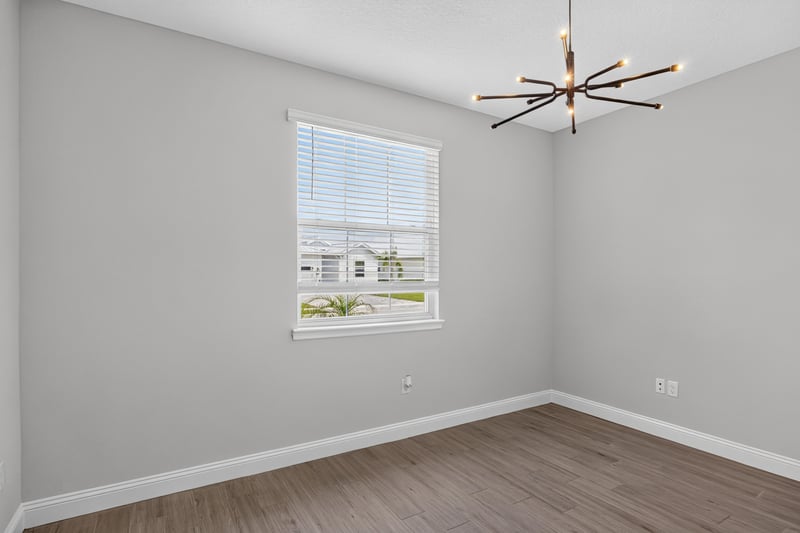 Bedroom with a modern chandelier at 91 Tilloo Ct, St. Johns, FL