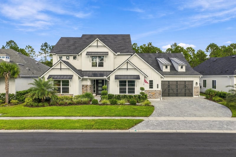 Front exterior daytime view with gable roofline and paver driveway at 907 Seagrove Dr, Ponte Vedra Beach, FL 32081