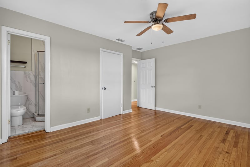 Bedroom with wood floors and closet doors at 217 Baisden Rd, Jacksonville, FL 32218