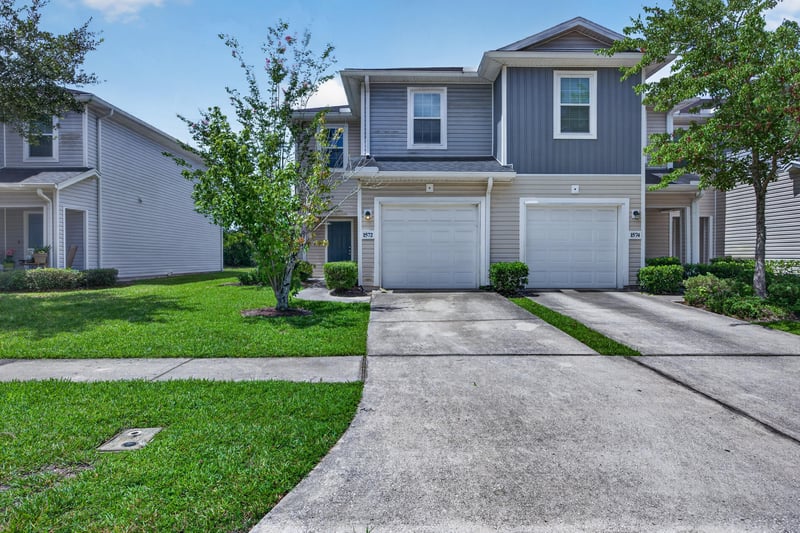 Front exterior with two-car garage and driveway at 1572 Biscayne Bay Dr, Jacksonville, FL 32218
