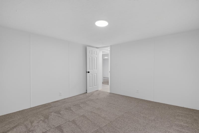 Empty room with carpet and door at 55520 Jewel-Thomas Rd, Callahan, FL 32011