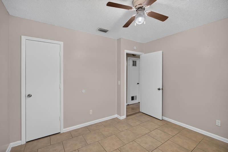 Bedroom with window and hallway doorway at 8067 Parental Cir, Jacksonville, FL 32216
