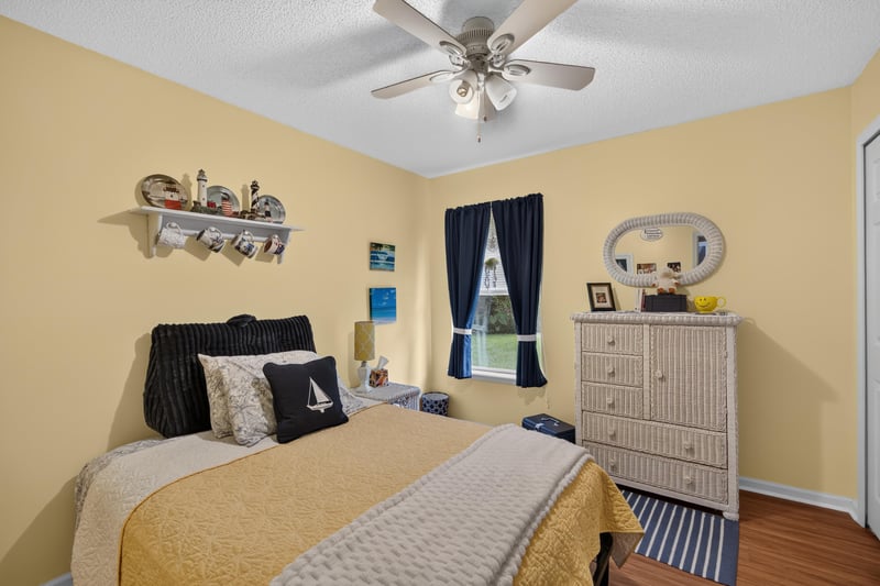 Bedroom with yellow walls and dresser at 13514 Las Brisas Way N, Jacksonville, FL