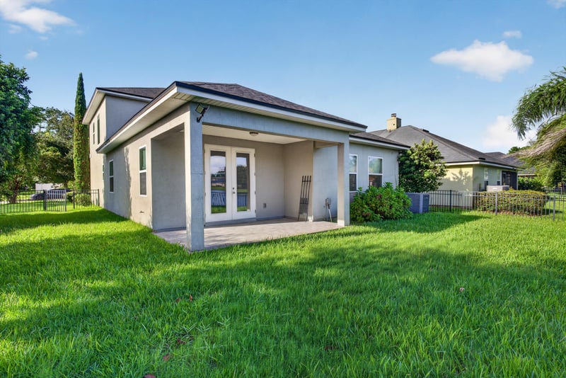 Rear exterior backyard with palm tree at 13685 Goodson Pl, Jacksonville, FL 32226