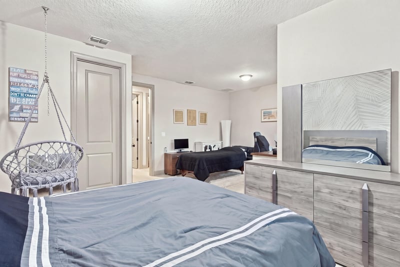 Bedroom with bunk beds and hanging chair at 3921 Spyglass Hill Ln