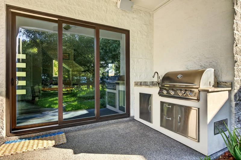Interior room with carpet and sliding glass door reflecting the patio at 722 3rd Ave N, Jacksonville Beach, FL