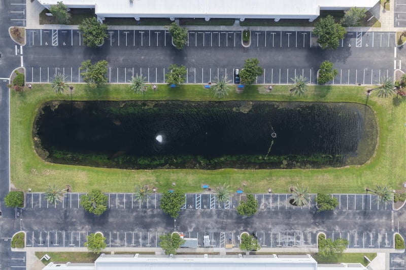 Aerial view of a rectangular pond with fountain between lots at 10550 Deerwood Park Blvd, Jacksonville, FL 32256