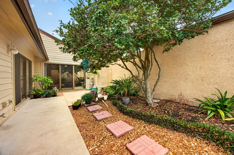 Side courtyard walkway with landscaping at 3407 Fairbanks Grant Rd N, Jacksonville, FL 32223