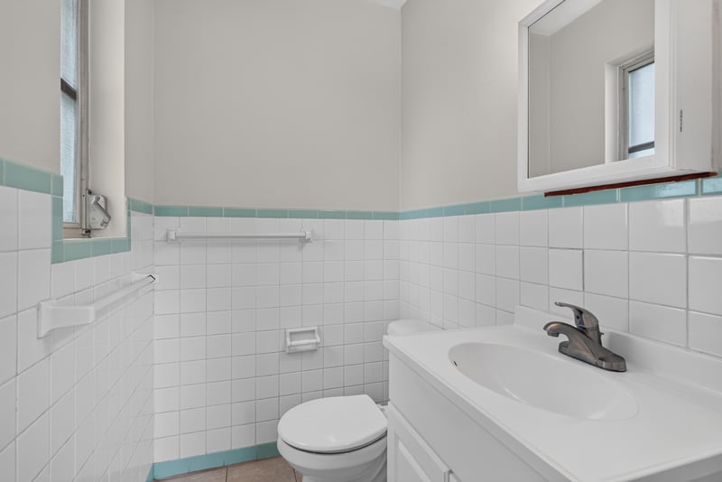 Bathroom with tile walls and tub at 2618 Arlex Dr E, Jacksonville, FL
