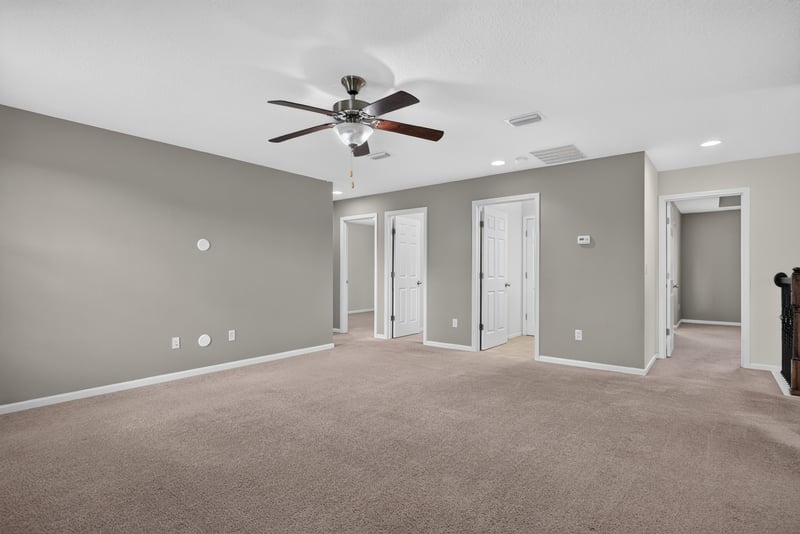 Upstairs hallway with carpet and multiple doors at 263 Gilmore Ln, Orange Park, FL 32065