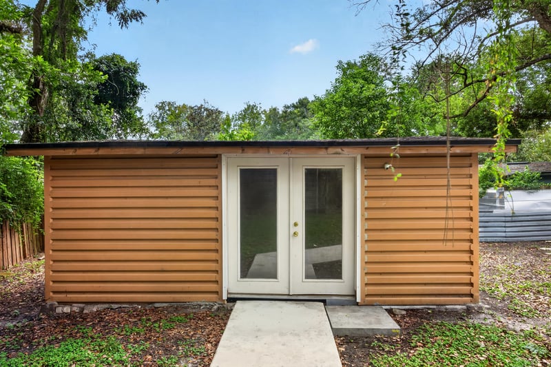Detached wood-sided structure with French doors at 7015 Miss Muffet Ln N, Jacksonville, FL 32210