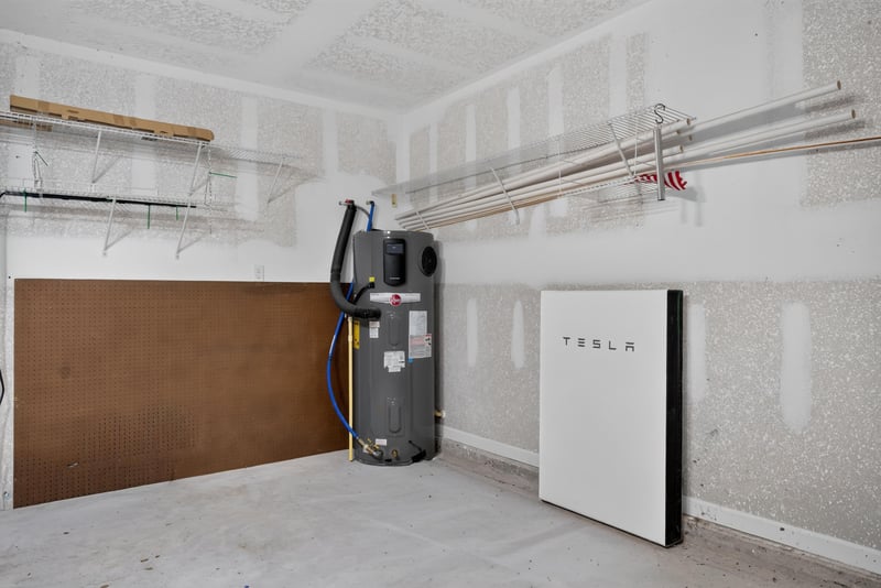 Garage with water heater and battery storage unit at 10066 Andean Fox Dr, Jacksonville, FL 32222