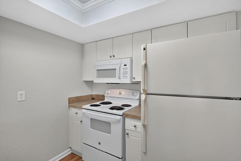 Kitchen with white microwave and refrigerator at 3866 Campenero Ct unit 6, Jacksonville, FL 32217