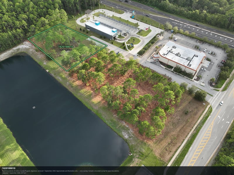 Aerial view of the pond and tree canopy bordering the building at 4900 US-1, St. Augustine, FL 32086