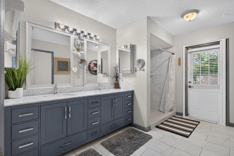 Bathroom with double vanity and dark cabinets at 8680 Bandera Cir S, Jacksonville, FL 32244