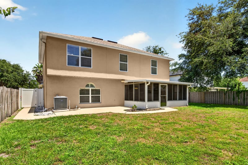 Back exterior with screened porch and trees at 3428 Glenn Hollow Ct, Jacksonville, FL 32226