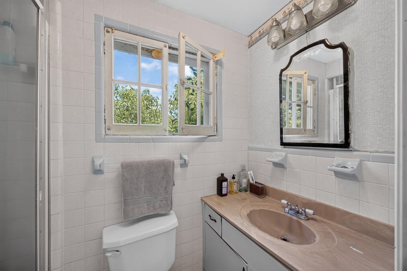 Bathroom with window and vanity mirror at 1173 US-17, Satsuma, FL 32189