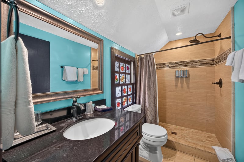 Bathroom with a vanity and blue accent wall at 115 Cordova St, St. Augustine, FL