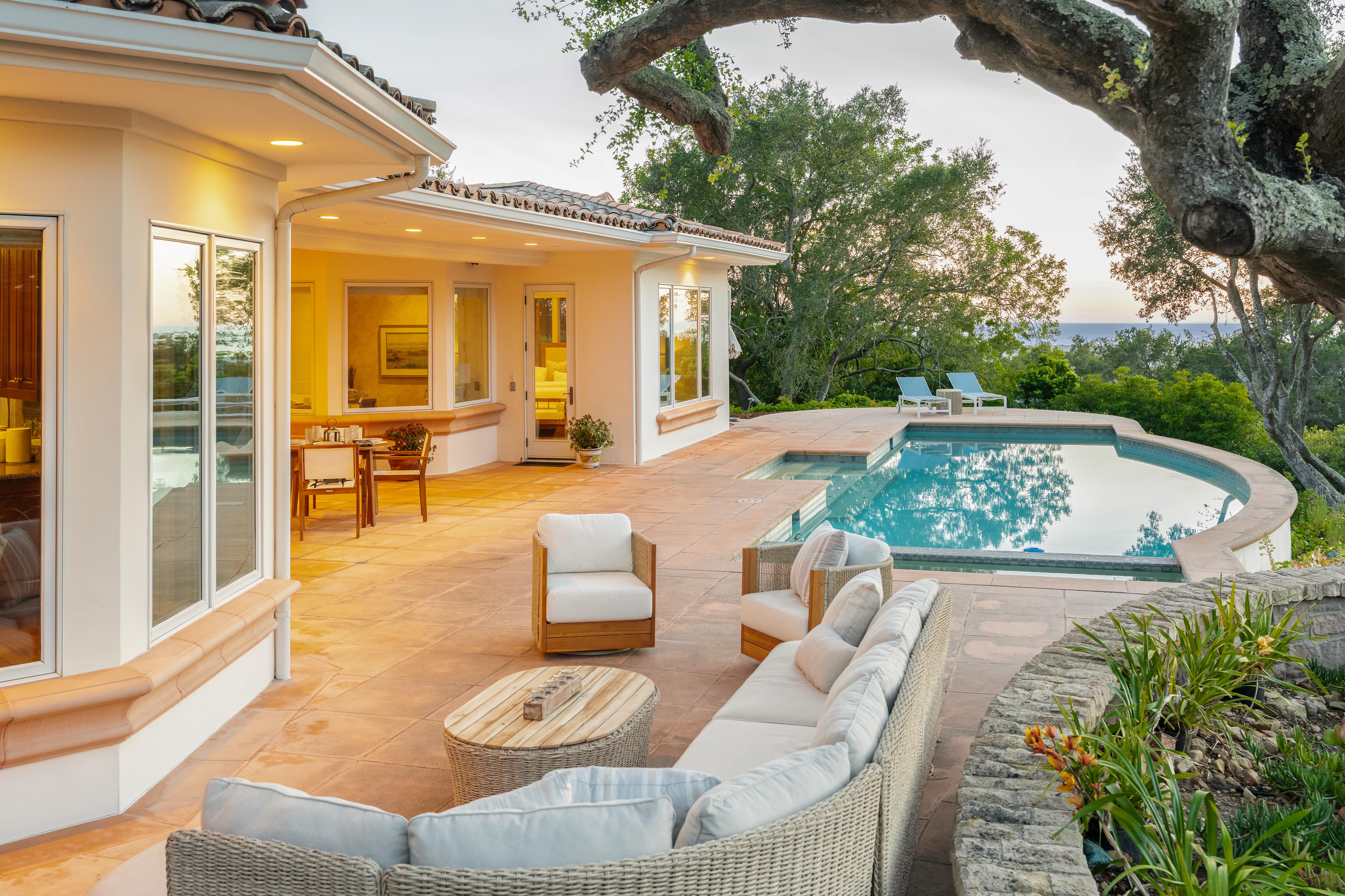 Twilight photography of estate exterior at 450 El Cielito Rd, Santa Barbara — virtual tour photography and twilight imaging capturing warm interior light against a violet Pacific sky above the American Riviera. Our team captured still photography, aerial drone photography, twilight photography, a Matterport virtual tour, a 2D floor plan, and a custom property website from afternoon through twilight.
