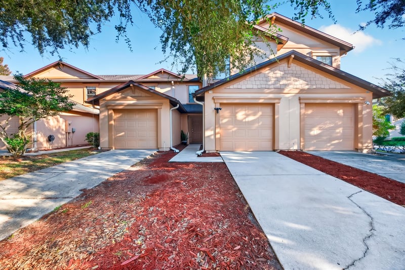 Front exterior view of garage and entry walkway at 7723 Playschool Ln, Jacksonville, FL