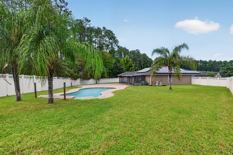 Backyard pool and fenced lawn at 706 Grampian Highlands Dr, St. Johns, FL 32259