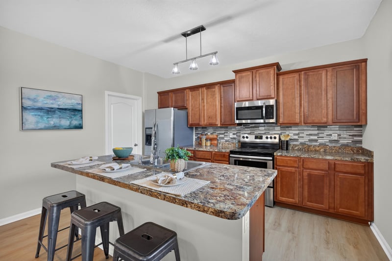 Kitchen view with upper cabinets and stainless range at 6830 Hanford St, Jacksonville, FL 32219
