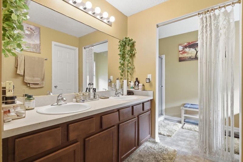 Primary bathroom with dual-sink vanity at 7392 Timber Falls Ct