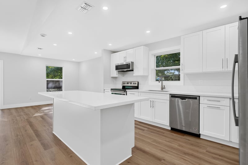 Kitchen island with dishwasher and white countertops at 8453 Boysenberry Ln W, Jacksonville, FL