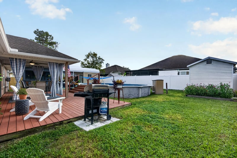 Deck with seating and grill near pool at 3112 Silverado Cir, Green Cove Springs, FL 32043