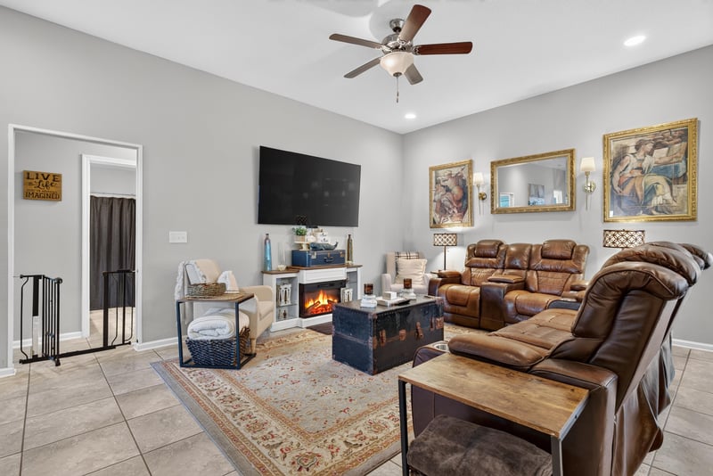 Living room with fireplace and mounted TV at 589 Seville Pkwy, St. Augustine, FL