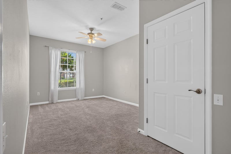 Bedroom with closet doors at 7990 Baymeadows Rd E #404, Jacksonville, FL 32256