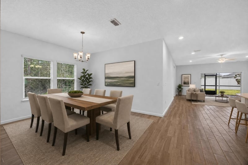 Dining room with wood table, virtually staged at 9905 Ansley Lake Dr, Jacksonville, FL